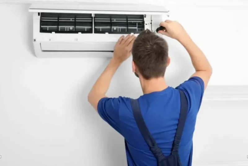 image showing a technician troubleshooting an air conditioner