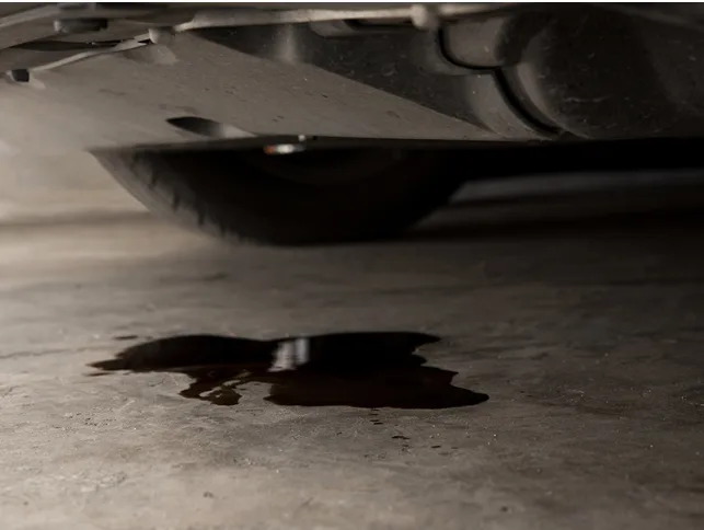 image showing a parked vehicle with a leaking engine oil